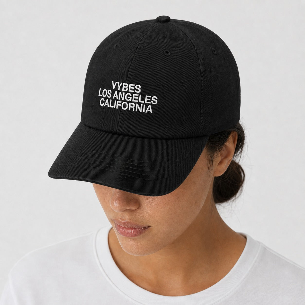 Person wearing the VYBES Dad Embroidered Cap in black