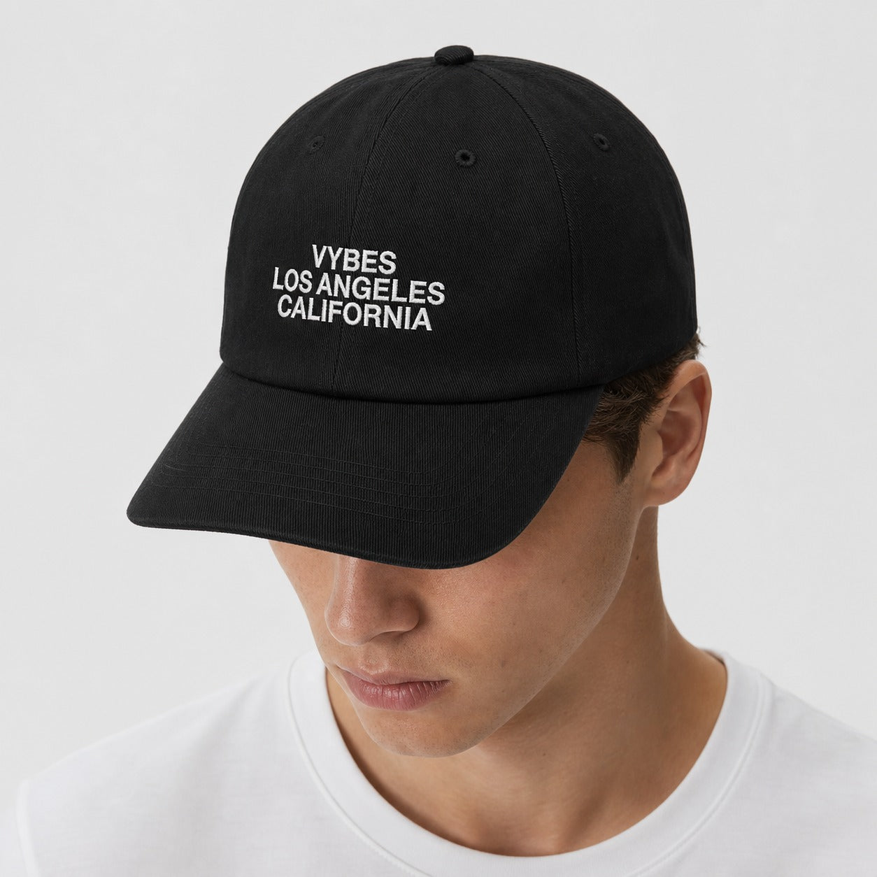 Person wearing the VYBES Dad Embroidered Cap in black